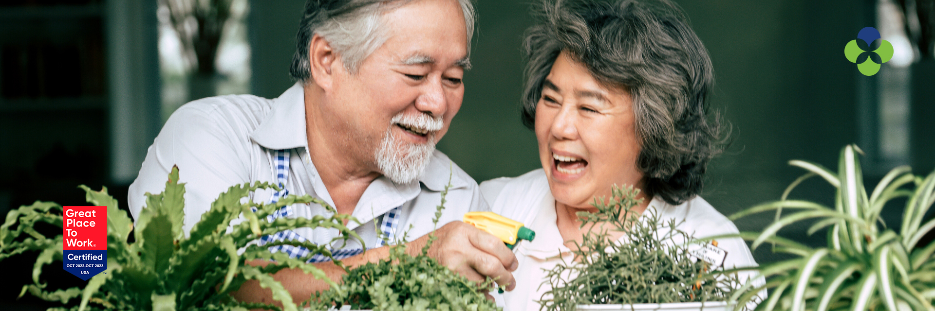 CNA with dark hair and patient both smiling at camera